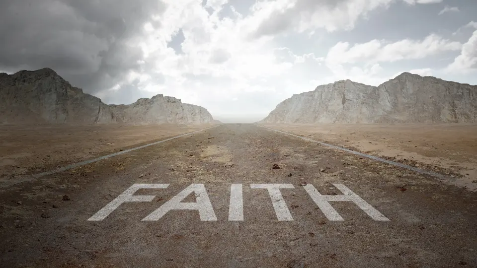 Word "Faith" overlaying a dirt road in the dessert.