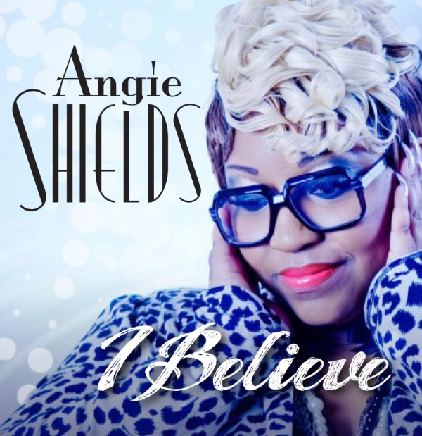 Album cover for “I Believe” by Angie Shields, featuring a woman with short blonde hair, large dark glasses, and a blue patterned outfit, smiling with her hands on her face against a light blue, dotted background.